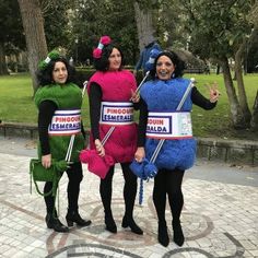 three women dressed up in costumes posing for the camera