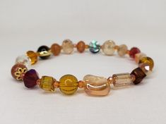 "This bracelet is beautifully handcrafted with crystals, glass, and gemstones. Featuring Tiger eye, Abalone, Czech crystals, Sandstone. With its versatile bead assortment, this bracelet goes with any outfit. You will be able to show off your unique style and make your wrist the center of attention. Most of my bracelets fit wrists between 6\" and 6.5\" size. Before placing an order, please confirm your size. Thank you" Hand-strung Czech Glass Crystal Bracelet As Gift, Elegant Czech Glass Crystal Bracelet With Faceted Beads, Adjustable Glass Crystal Bracelet With Faceted Beads, Faceted Czech Glass Bracelets As Gift, Glass Crystal Bracelet With Faceted Round Beads, Faceted Czech Glass Crystal Bracelet, Multicolor Glass Crystal Bracelet With Faceted Beads, Czech Glass Crystal Bracelet With Spacer Beads, Faceted Beads Czech Glass Bracelets For Healing