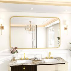 a bathroom vanity with two sinks and a large mirror above it, in front of a white wall