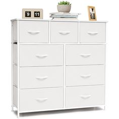 a white dresser with drawers and a clock on top