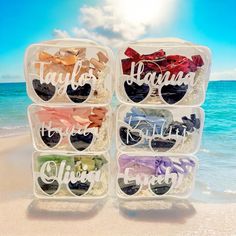 four clear plastic containers with personalized sunglasses on the beach