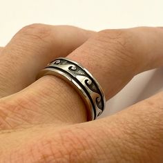 a person's hand with a silver ring on it