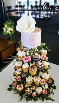 a wedding cake made out of cupcakes and flowers