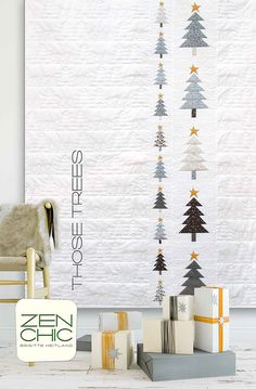 a white wall hanging with christmas trees on it and presents in front of the wall