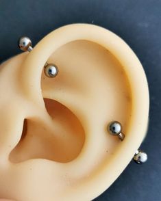 an ear with three balls attached to it