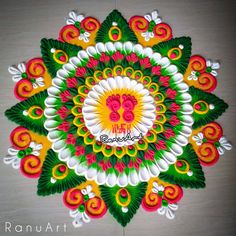 an intricate design on the floor with colorful colors and designs, including red, green, yellow and white