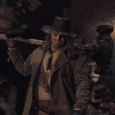 a man in a hat and trench coat holding a large metal object over his shoulder