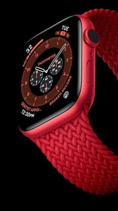 an apple watch with red braiding on the side and black background, in front of a