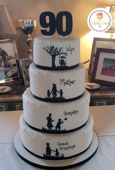 a three tiered cake with the number 90 on it's side and silhouettes of people holding hands