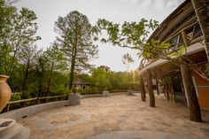 an outdoor area with large vases and trees