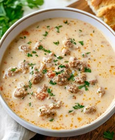 a bowl of soup with meatballs and parsley