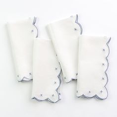 three white napkins with blue stars on them