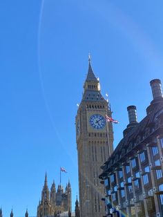 the big ben clock tower towering over the city of london on a bright sunny day