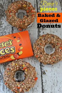 three doughnuts sitting on top of a wooden table