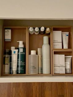 a wooden shelf filled with lots of different types of skin care products