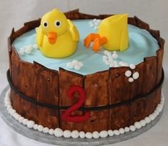 there is a cake with two rubber ducks in the water