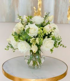 a vase filled with white flowers on top of a table