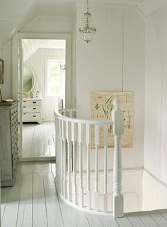 a room with white walls and wooden floors