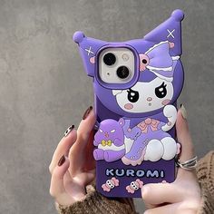 a person holding up a purple phone case with an image of a cat on it