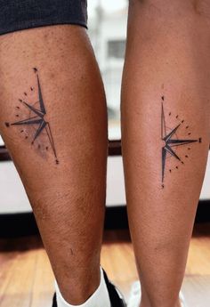 two people with tattoos on their legs and one has a compass tattoo on his leg