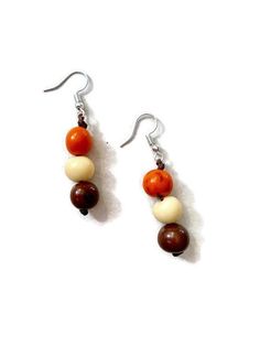 Ecuadorean Tagua Jewelry - Eco Friendly Color: Orange, Brown, Beige Item Number: TAG634 Item Weight: 1.4oz Product Length: 46 inches long About Tagua This Product is handcrafted from a palm tree nut native to the lush tropical rainforests of Ecuador. Also referred to as the Ecuadorean Ivory Palm, the Tagua tree produces several bushels of seed pods a year with up to 100 Tagua nuts per pod. These nuts are then harvested, dried, and crafted into a wide range of products from vibrant modern jewelry White Jewelry With Wooden Beads, White Jewelry With Round Wooden Beads, Beige Dangle Jewelry With Ear Wire, Beige Drop Earrings With Ear Wire, Beige Wooden Beads Jewelry As A Gift, Tagua Necklace, Ivory Necklace, Tagua Jewelry, Tagua Nuts