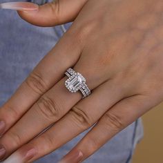 a woman's hand with a diamond ring on her finger and an engagement band