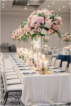 a long table with flowers and candles on it is set up for a formal function