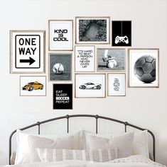 a white bed topped with lots of pictures and posters on the wall next to a metal headboard