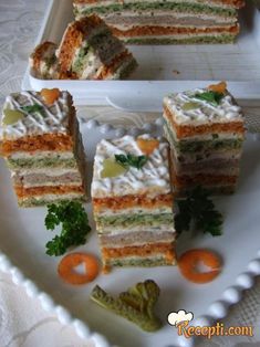 several pieces of cake on a plate with carrots and celery next to it