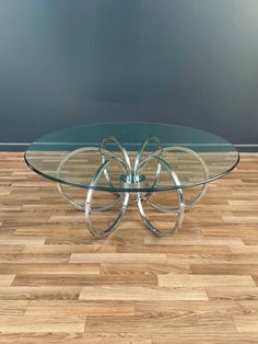 a glass and chrome coffee table on wooden floor