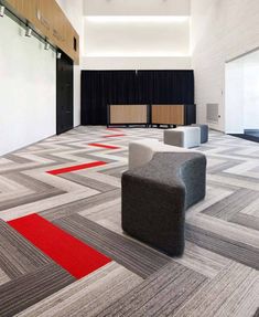 an empty room with chairs and rugs on the floor