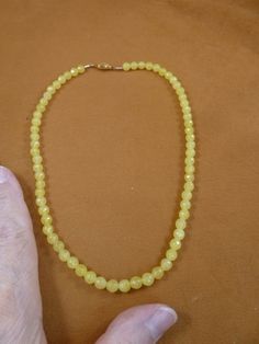 (Internal #V-308-41) You are bidding on a beautiful, handmade, necklace made with6 mm faceted yellow jade beads. Necklace is 16" long, with gold safety clasp closure.  * Want something longer, special order is $3.00 per inch. WE SHIP WORLDWIDE!  Other accepted payment: Credit card (Mastercard/Visa/Discover) inquire for details. Yellow Faceted Beads Round Jewelry, Yellow Round Faceted Beads Jewelry, Yellow Jewelry With Faceted Round Beads, Yellow Gemstone Beaded Necklaces, Yellow Faceted Beaded Necklaces, Yellow Faceted Beads Round Necklace, Yellow Faceted Beads Beaded Necklace, Yellow Faceted Beads Necklace, Yellow Faceted Beaded Necklace