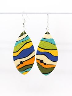 Handmade polymer clay earrings. Multicolour dangles with abstract pattern, perfect for various occasions. They are finished matte and with alloy wire hooks. Your earrings will be stored within a pillow gift box and posted in a padded envelope for added protection. CARING FOR YOUR EARRINGS * do not store it in purses or pockets * put on earrings after all make-up, hairspray, and perfume has been applied * if necessary, clean with a baby wipe, make-up wipe or soap and water Each piece of jewellery is completely unique - no two patterns will be the same. The clay may have small characteristic imperfections due to the nature of the production process. Please note that due to variations amongst computer monitors, actual colours may vary slightly from what appears on your screen. Modern Adjustable Multicolor Earrings, Multicolor Abstract Design Earrings As Gift, Multicolor Abstract Design Earrings For Gift, Hand Painted Multicolor Clay Jewelry, Modern Multicolor Polymer Clay Earrings, Multicolor Polymer Clay Earrings, Polymer Clay Earrings Bright Colors, Whimsical Multicolor Polymer Clay Earrings, Multicolor Polymer Clay Drop Earrings