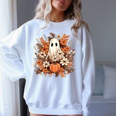 Halloween Sweatshirt,Retro Floral Ghost Sweatshirt,Halloween Wildflower Sweatshirt,Cute Ghost Sweatshirt,Vintage Ghost Sweat,Gift for Womens **Product Specifications** - Made from a 50/50 blend of Cotton and Polyester, ensuring both comfort and durability. - The fabric is medium to heavy weight, designed for extended wear. - Includes a tear-away label for easy removal. - Provides a relaxed fit while staying true to standard sizing. **How to Order** 1. Carefully examine the product images and siz Vintage Halloween Long Sleeve Sweatshirt, Vintage Long Sleeve Halloween Sweatshirt, Retro Long Sleeve Halloween Tops, Horror Long Sleeve T-shirt For Fall, Retro White Tops For Halloween, Retro White Top For Halloween, Fall Horror Crew Neck Sweatshirt, Horror Crew Neck Sweatshirt For Fall, Horror Style Crew Neck Sweatshirt For Fall