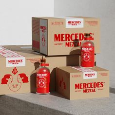 three boxes are stacked on top of each other with red ketchup bottles in them