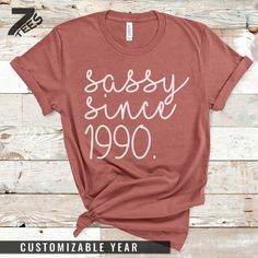 a t - shirt with the words sassy since 1989 printed in white on it