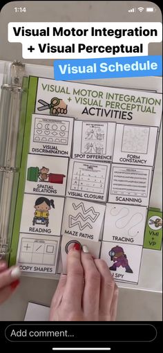 a hand holding a pen and pointing to a visual information sheet on a table with other items