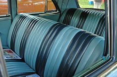 the interior of an old car with blue leather seats and matching dash tape on it