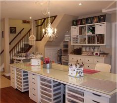 a kitchen with lots of counter space and drawers on the island in front of it