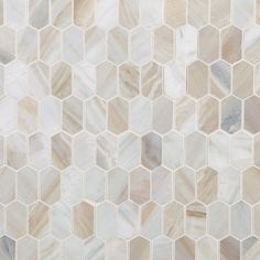 a white and beige mosaic tile pattern with hexagonal tiles on the bottom half