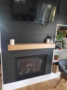 a television mounted on the wall above a fireplace