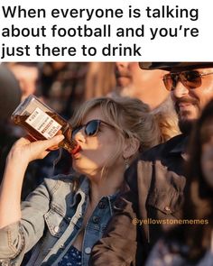 a woman drinking from a bottle while standing next to a man with sunglasses on her head