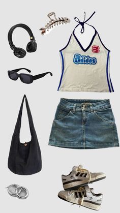 a woman's outfit with headphones, sunglasses and other items on top of it