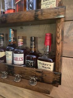 an old wooden shelf with liquor bottles on it