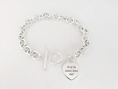 "Our 925 Sterling Silver Toggle Bracelet is a timeless piece of jewelry that captures both elegance and sentiment. The heart-shaped toggle clasp can be engraved with your choice of text, making this bracelet a deeply personal and cherished piece. Select heart or loop toggle. The bracelet features links in a classic cable design, each measuring 10.5mm by 8.5mm. The highlight of this bracelet is the heart-shaped toggle clasp, which can be personalized with an engraving of your choice. FEATURE: 925 Toggle Bracelet, Celtic Jewelry, Toggle Clasp, Necklace Sizes, Chain Link Bracelet, Cable Chain, Bracelet Making, Chain Bracelet, Chain Link