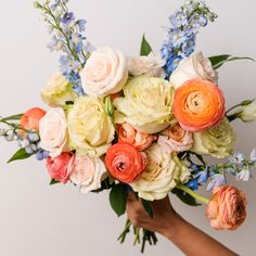 a person holding a bouquet of flowers in their hand