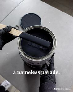 a person holding a paint can with the words a nameless parade written on it