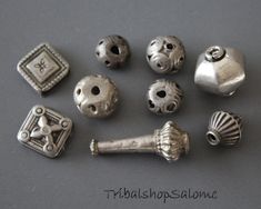 Mix of old handmade silver beads from the Central Asia. Origin: Kashmir, Afghanistan and Gilgit (Gilgit-Baltistan in the very north of Pakistan). Size:  Square beads 15 x 15 mm with two holes Longish bead 33 mm Big bead 18 x 19 mm Other beads 10 - 12 mm Quantity: 9 beads Silverquality 900 or higher Weight 31 g for all together Vintage Silver Beads For Gifts, Vintage Handmade Silver Beads, Handmade Vintage Silver Beads, Artisan Silver Spacer Beads, Artisan Silver Beads For Jewelry Making, Traditional Silver Round Beads, Handmade Silver Beads For Crafting, Gilgit Baltistan, Square Beads