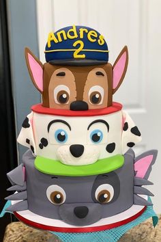 there is a three tiered cake made to look like the characters from disney and pixama