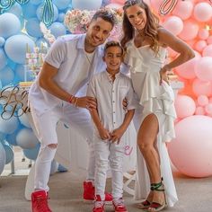 a family posing for a photo in front of balloons